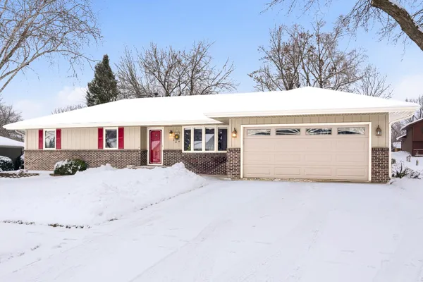 a view of a house with a yard covered with snow in front of house