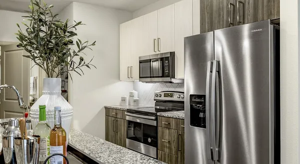a kitchen with stainless steel appliances a refrigerator a stove and a sink