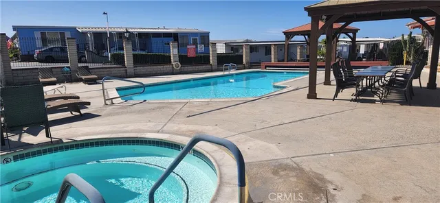 a swimming pool with outdoor seating yard and patio