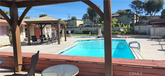 a view of a patio with swimming pool table and chairs