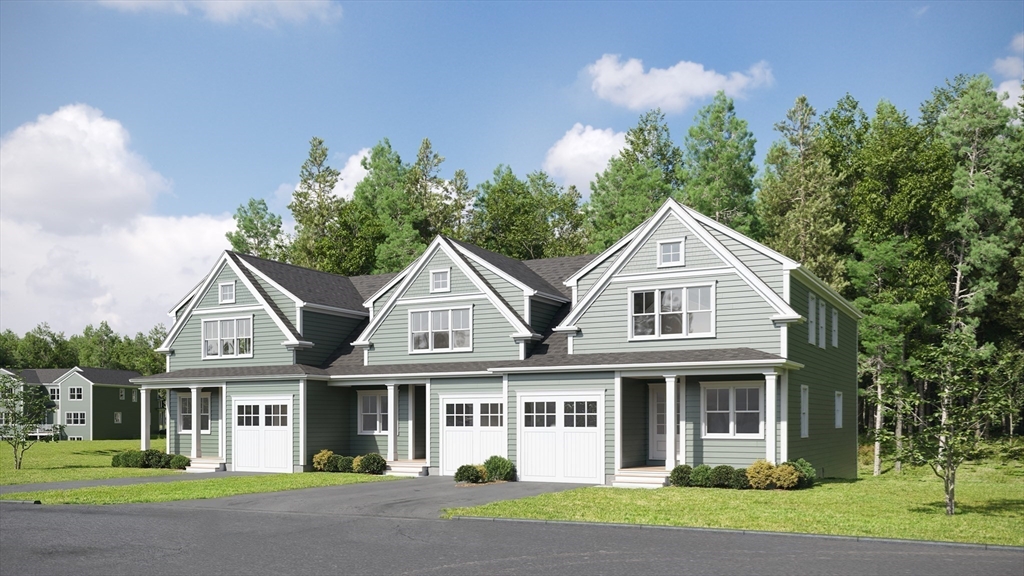69 Pine Tree Road, Unit 69 Holden, MA 01520 - Photo 1 of 22 a front view of a house with a yard and trees