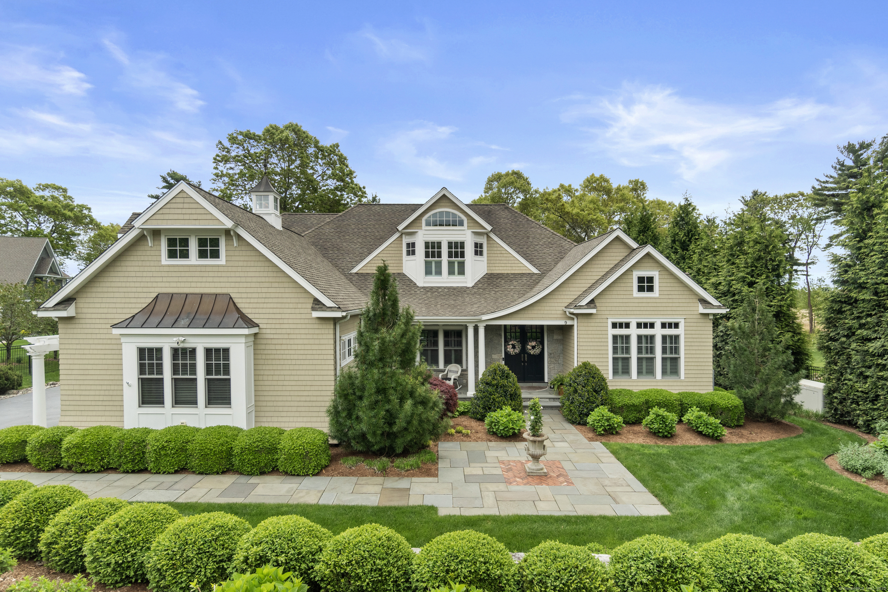9 Whisper Cove Road Old Saybrook, CT 06475 - Photo 1 of 1 Embrace the Elegance: A majestic Colonial facade sets the stage for serene cove views blending architectural beauty with a touch of natures tranquility.