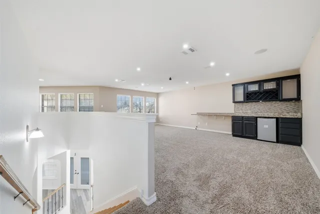 a view of kitchen with cabinets stainless steel appliances and wooden floor