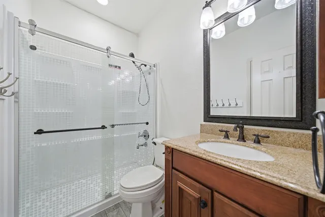 a bathroom with a glass shower door