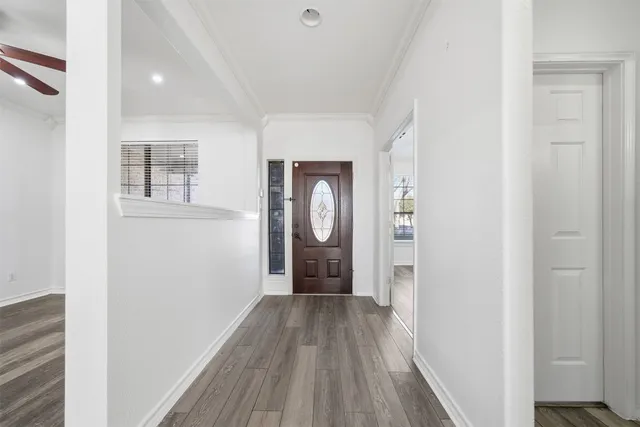 a view of a hallway with wooden floor and closet