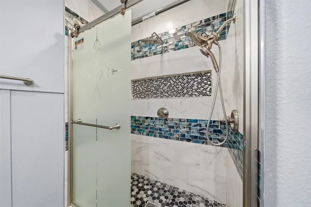 a bathroom with a granite countertop sink mirror and toilet