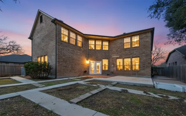a view of a yard with plants and trees
