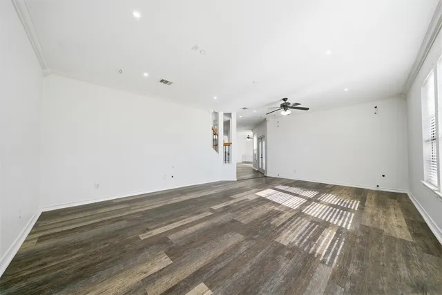 a view of empty room with wooden floor