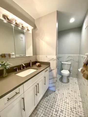a bathroom with a double vanity sink and a mirror