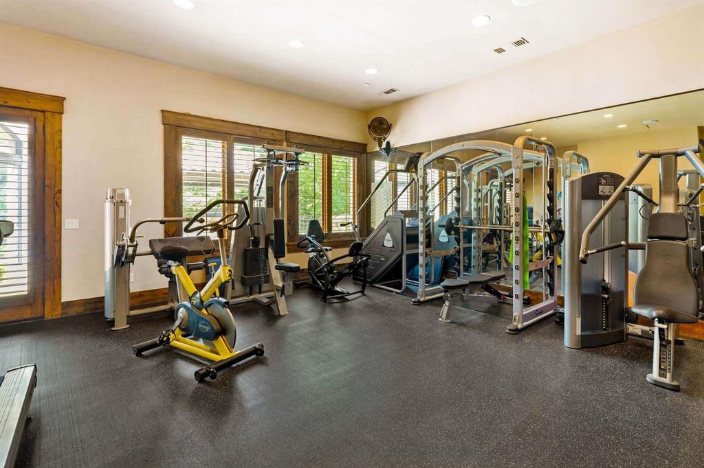 2115 Paradise Rnch Trail McKinney, TX 75071 - Photo 19 of 40 Dedicated fitness room featuring rubber flooring, recessed lighting, and mirrored walls