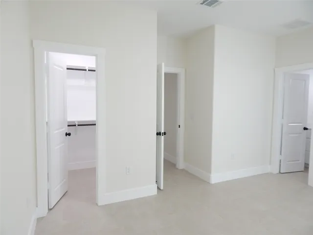a view of an empty room and closet area