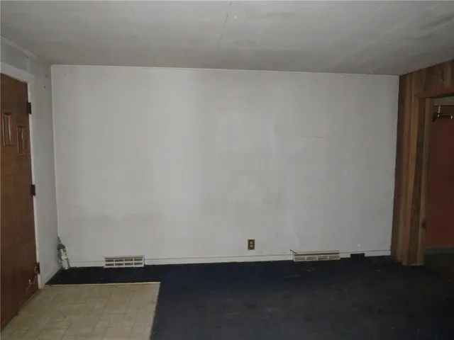 an empty room with wooden floor