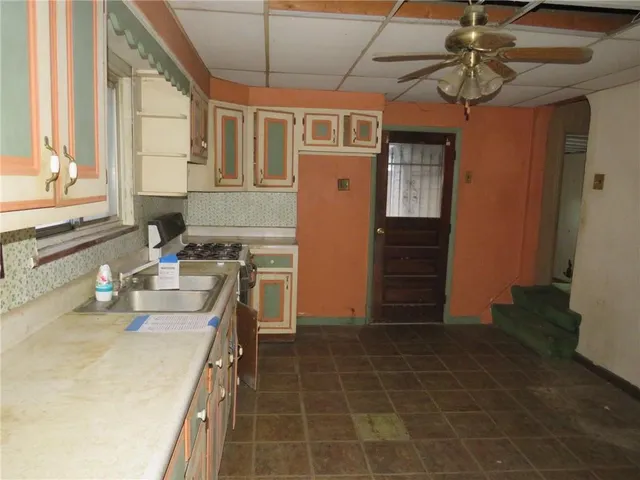 a kitchen with a sink a stove and a refrigerator