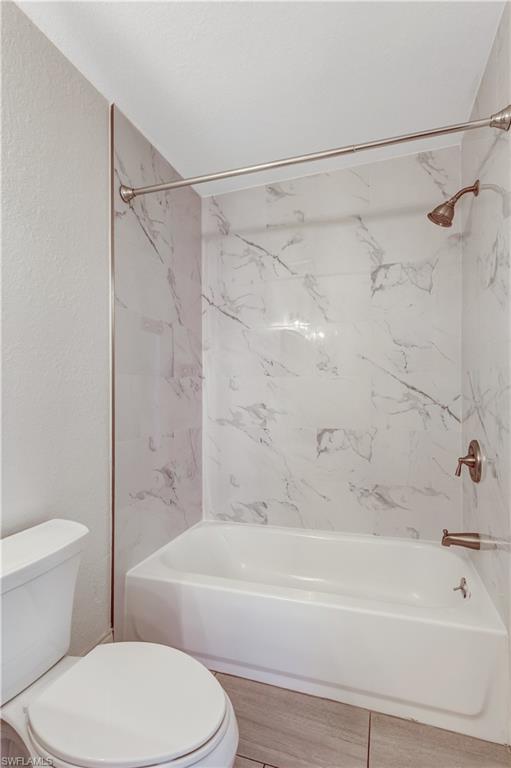 8285 Ibis Club Drive, Unit 807 Naples, FL 34104 - Photo 18 of 42 a bathroom with a toilet and a bath tub