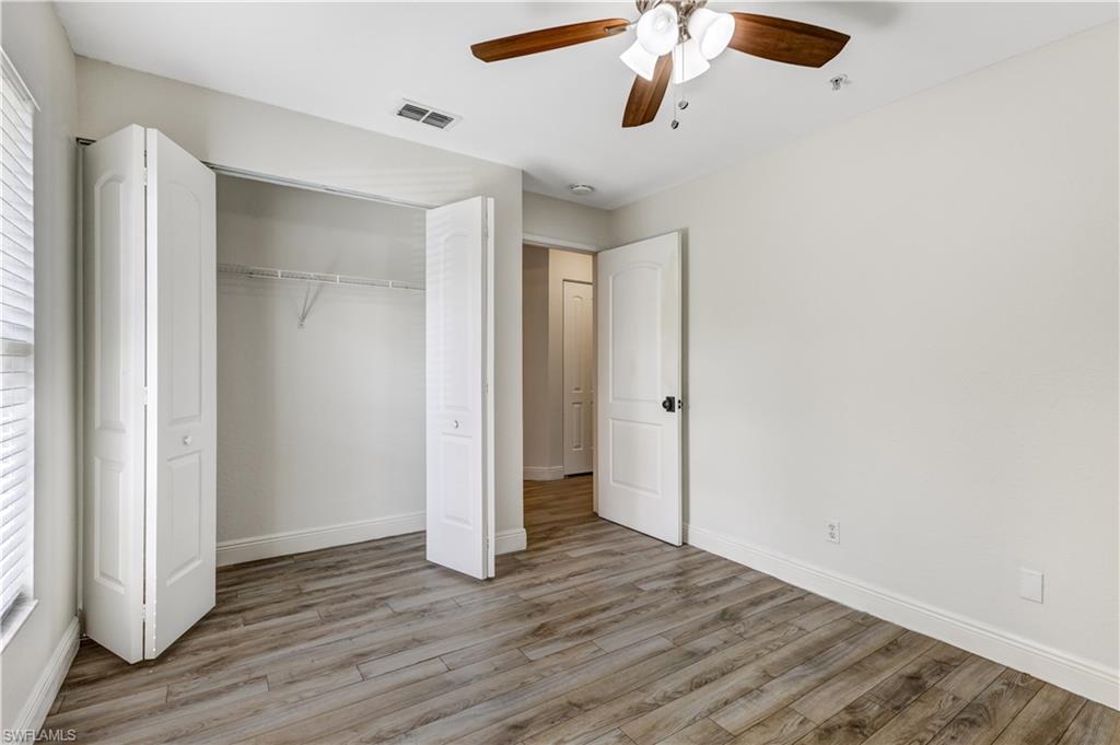 8285 Ibis Club Drive, Unit 807 Naples, FL 34104 - Photo 21 of 42 a view of an empty room with wooden floor