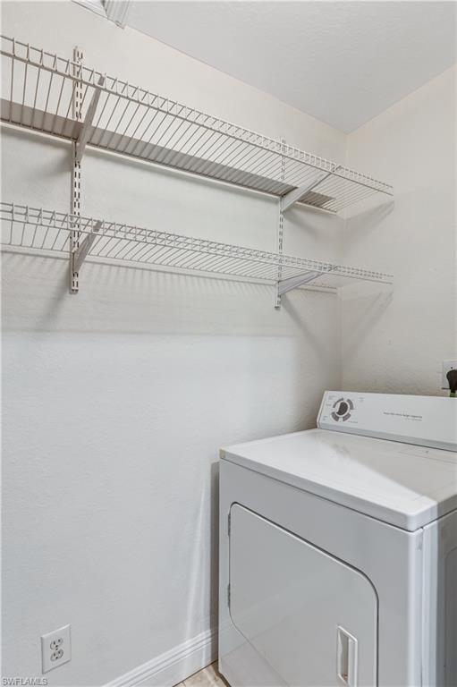 8285 Ibis Club Drive, Unit 807 Naples, FL 34104 - Photo 24 of 42 a utility room with dryer and washer