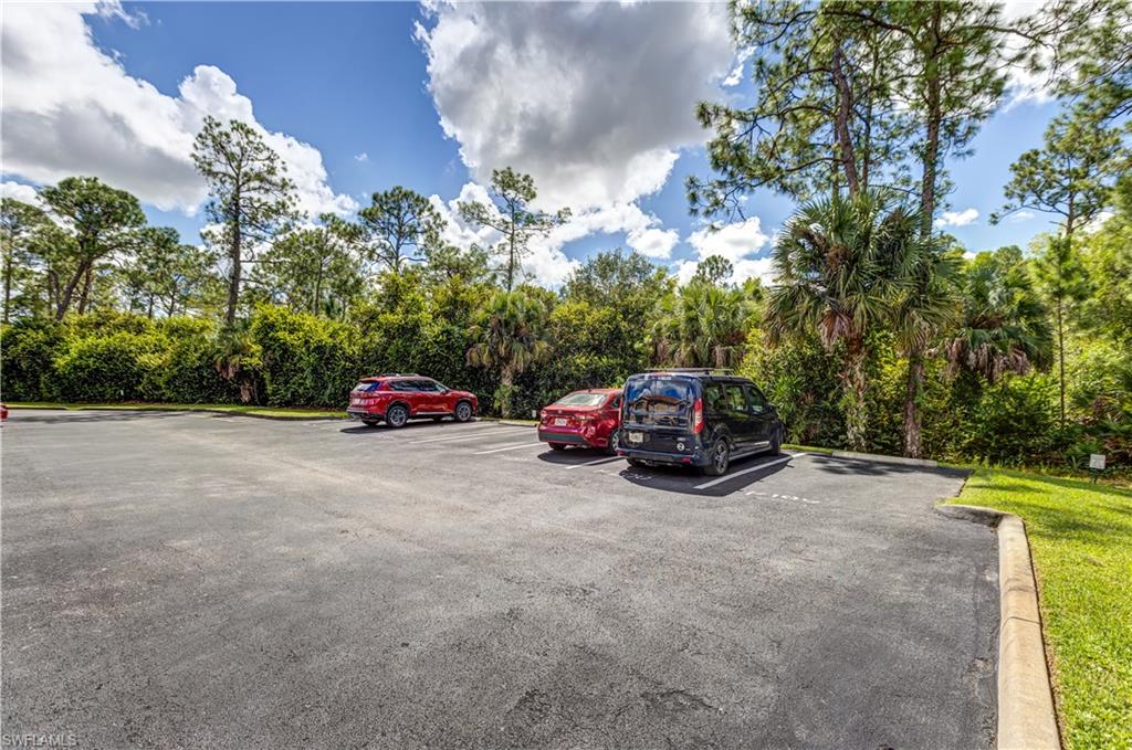 8285 Ibis Club Drive, Unit 807 Naples, FL 34104 - Photo 33 of 42 a view of a car parked on the side of road with trees