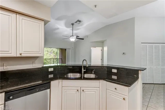 a kitchen with granite countertop a sink and cabinets