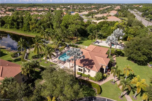 an aerial view of residential houses with outdoor space and river