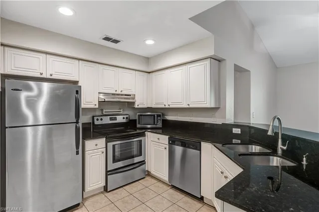 a kitchen with a refrigerator stove and sink