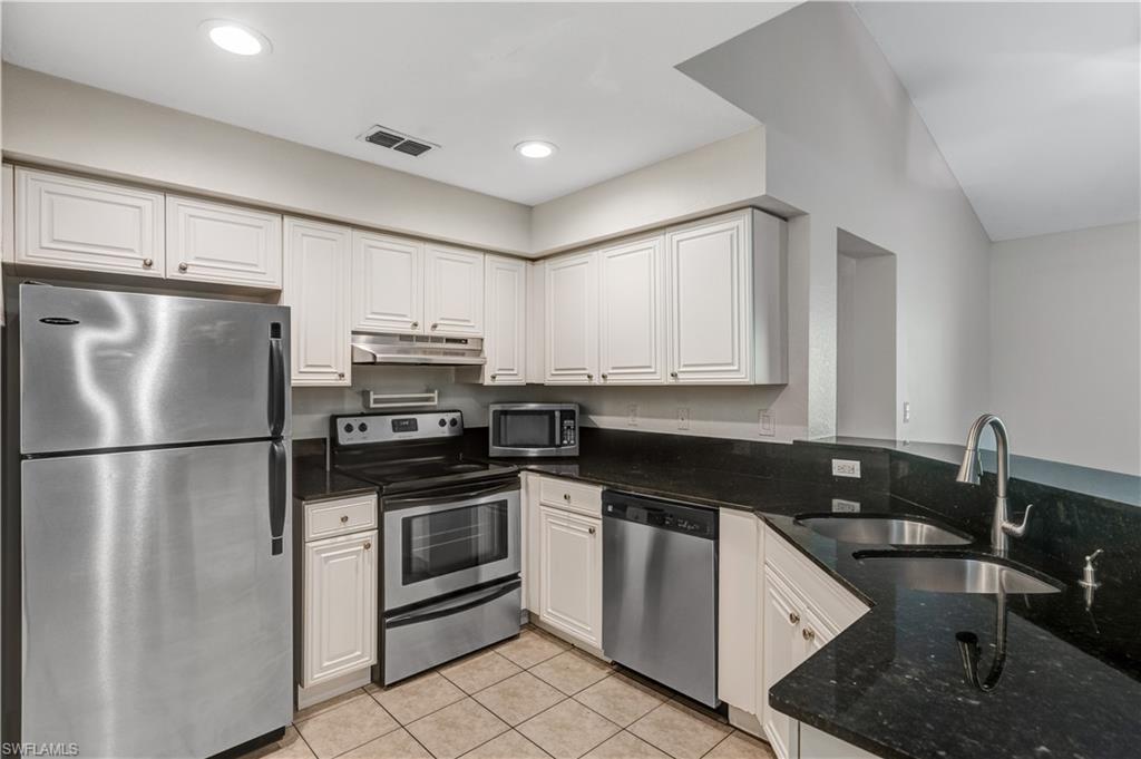 8285 Ibis Club Drive, Unit 807 Naples, FL 34104 - Photo 5 of 42 a kitchen with a refrigerator stove and sink