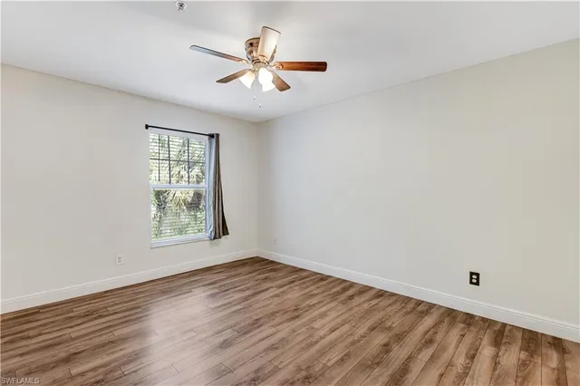 wooden floor in an empty room with a window