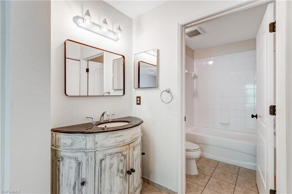 8285 Ibis Club Drive, Unit 807 Naples, FL 34104 - Photo 10 of 42 a bathroom with a sink a toilet and shower