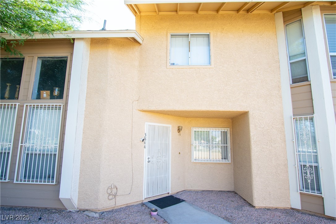Property entrance featuring stucco siding