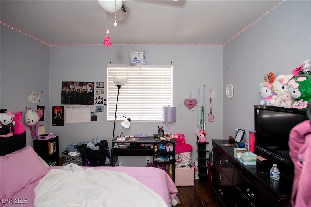 3844 Fitzpatrick Drive Las Vegas, NV 89115 - Photo 11 of 23 Bedroom featuring dark wood-style flooring and ceiling fan