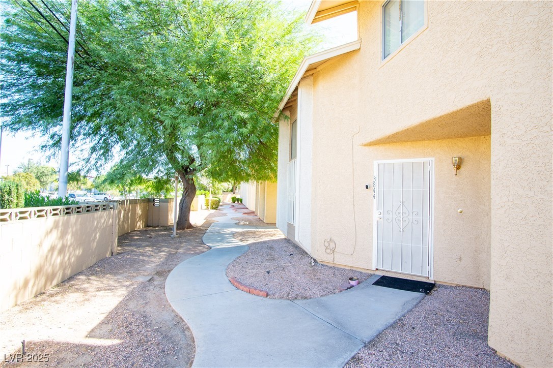 3844 Fitzpatrick Drive Las Vegas, NV 89115 - Photo 2 of 23 Doorway to property featuring stucco siding