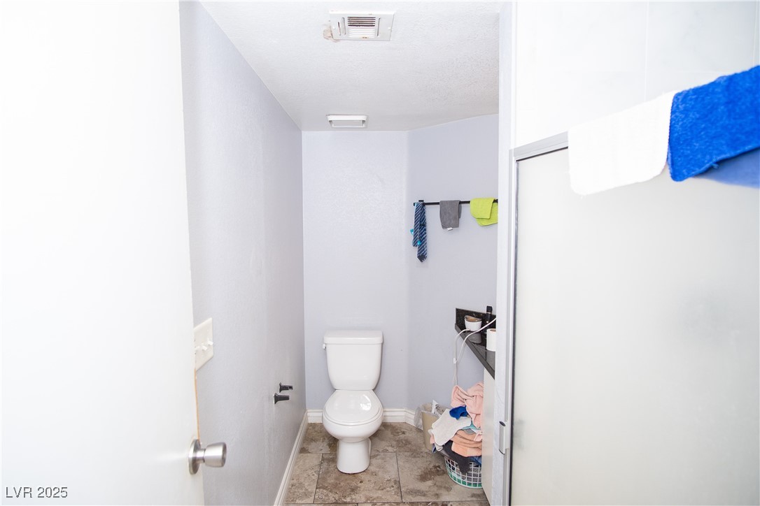 3844 Fitzpatrick Drive Las Vegas, NV 89115 - Photo 10 of 23 Bathroom with toilet and baseboards