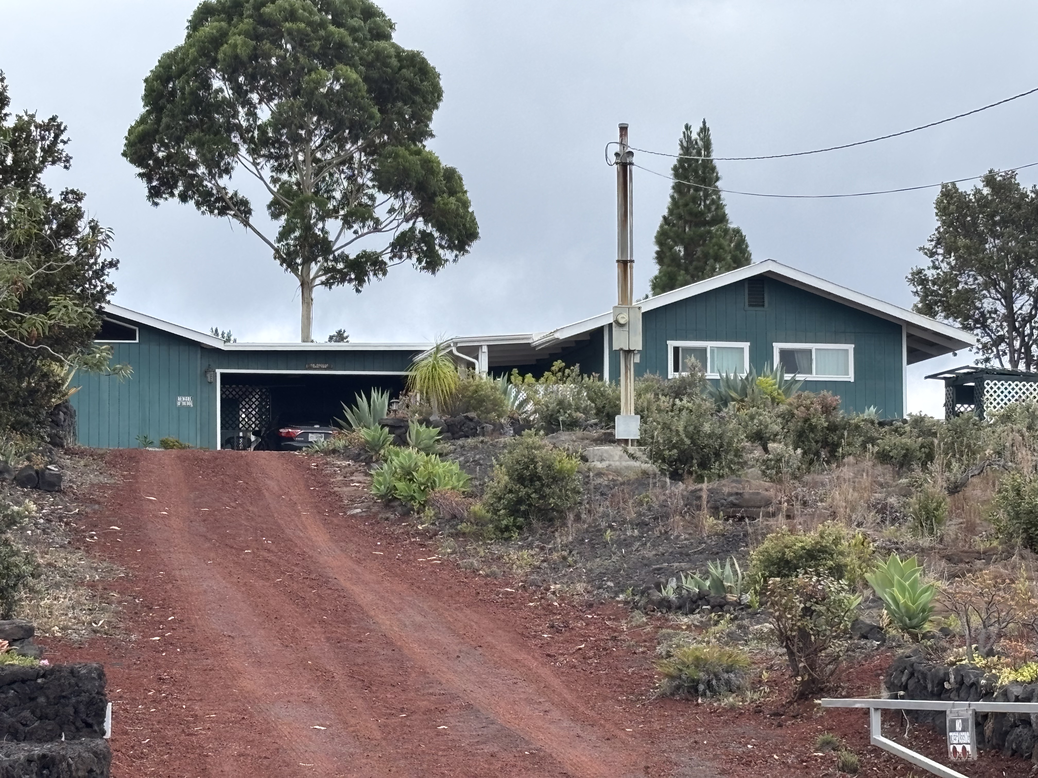 92-8564 Koa Lane Ocean View, HI 96704 - Photo 3 of 30 a front view of a house with garden