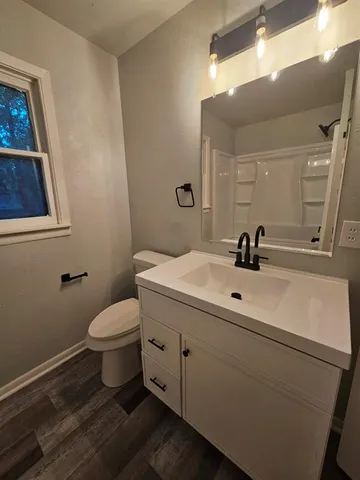 a bathroom with a sink a toilet and mirror