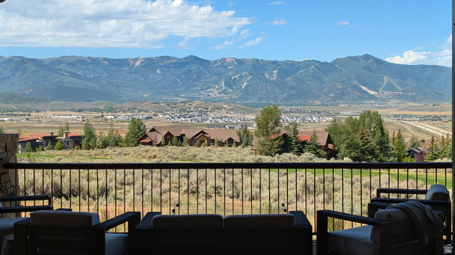 7885 North Rabbitbrush Court, Unit 13 Park City, UT 84098 - Photo 67 of 88 Spacious outdoor patio with a metal railing, stone column, and expansive mountain scenery