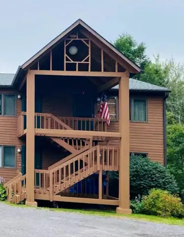 a view of a house with brick walls and deck