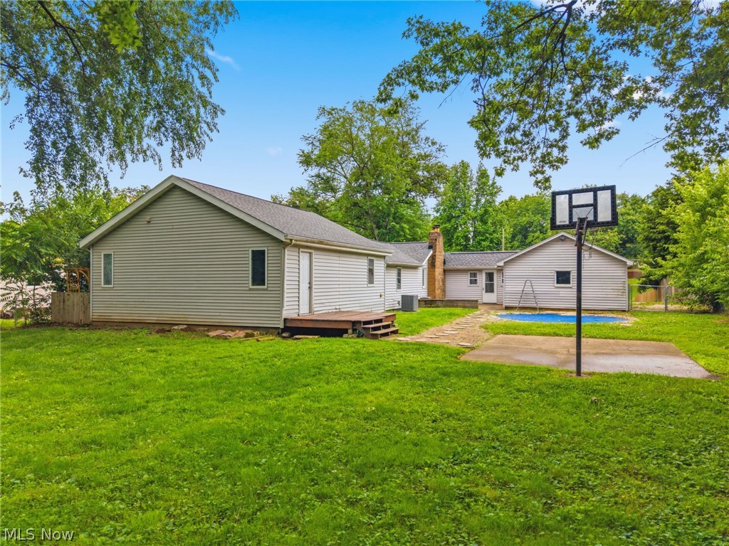 4449 18th Street Northwest Canton, OH 44708 - Photo 22 of 25 Expansive green lawn with a basketball hoop on a concrete pad