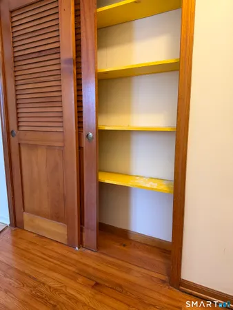 a view of a room with wooden floor