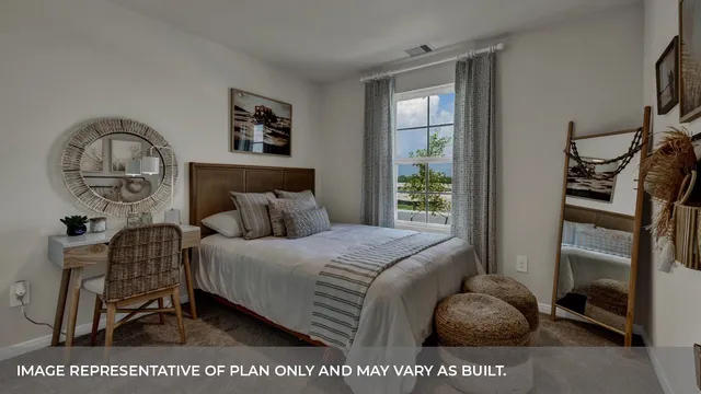 a bedroom with a bed next to a window