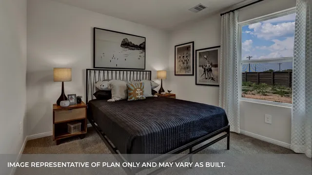 a bed sitting in a bedroom next to a window