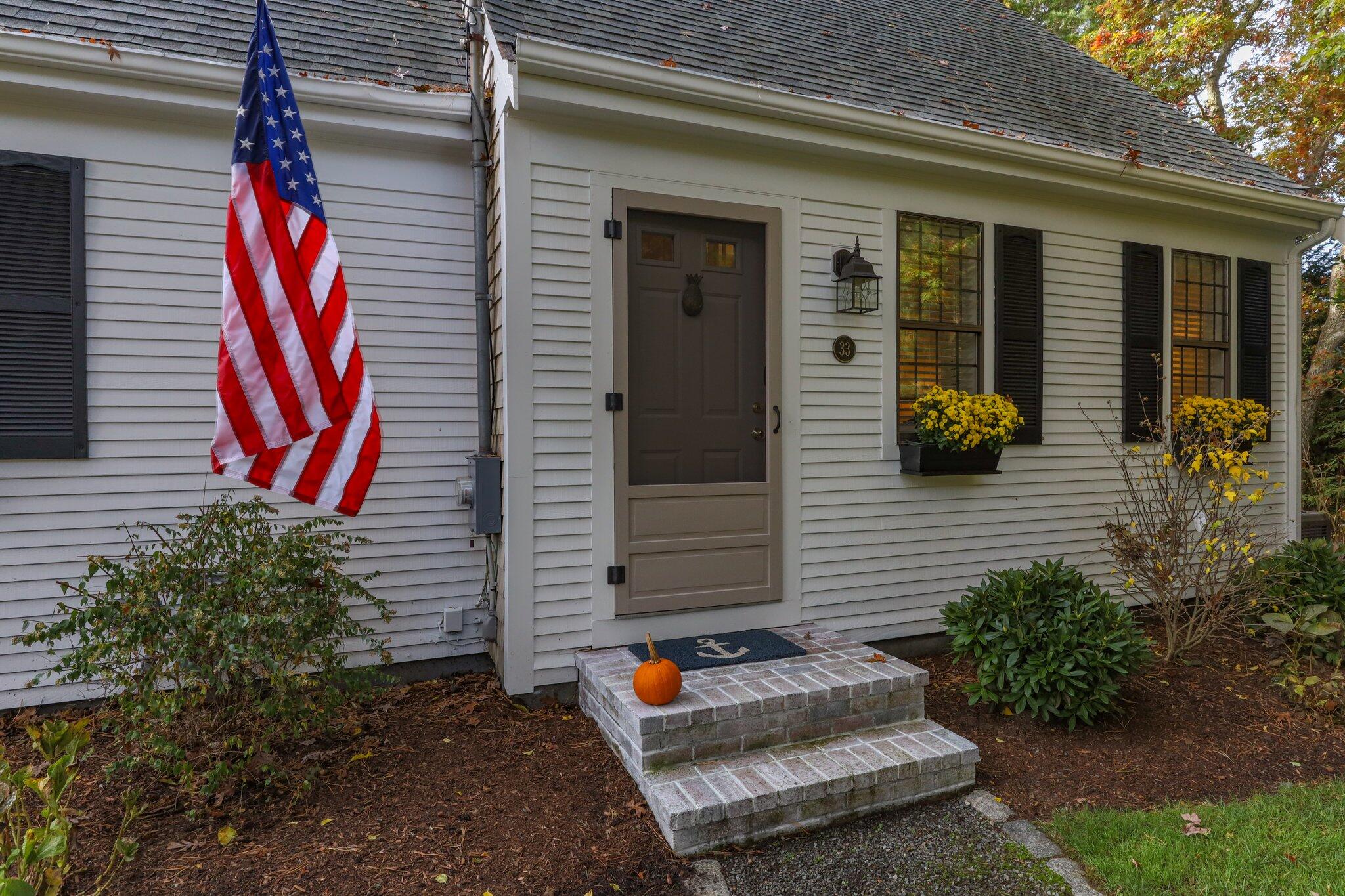 33 Waterfield Road Osterville, MA 02655 - Photo 6 of 40 a backyard of a house with seating space
