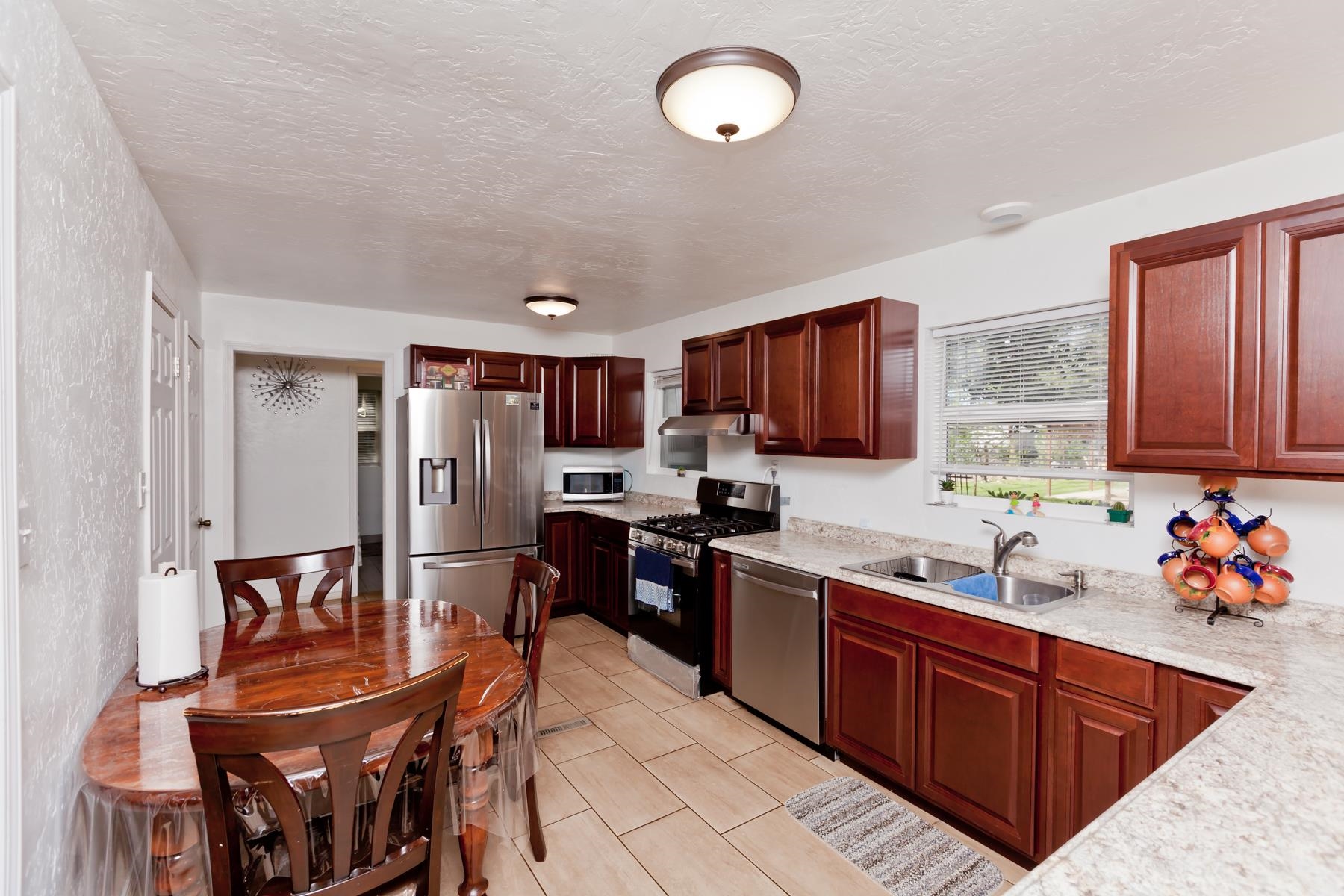 263 29 Road Grand Junction, CO 81503 - Photo 7 of 26 a kitchen with stainless steel appliances granite countertop a sink dishwasher stove top oven and wooden cabinets
