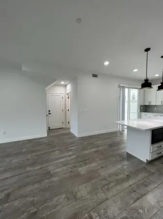 a kitchen with stainless steel appliances granite countertop a refrigerator a sink and a stove