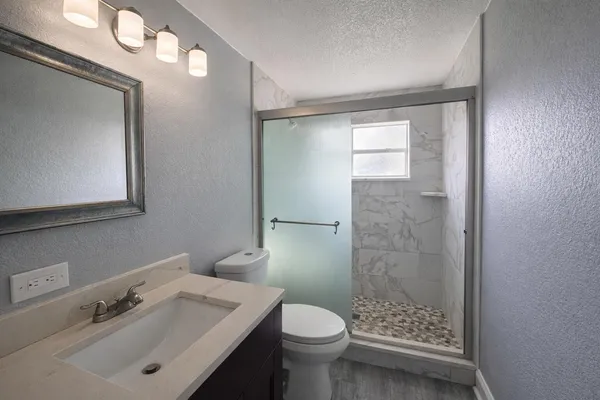 a bedroom with a bed and a potted plant