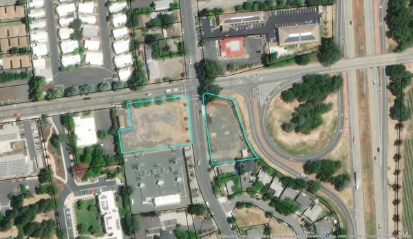 an aerial view of residential houses with outdoor space and plants