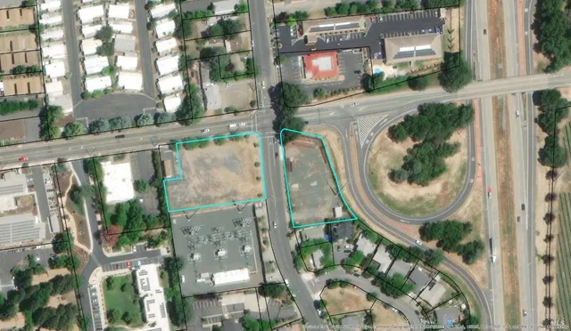 an aerial view of residential houses with outdoor space and plants