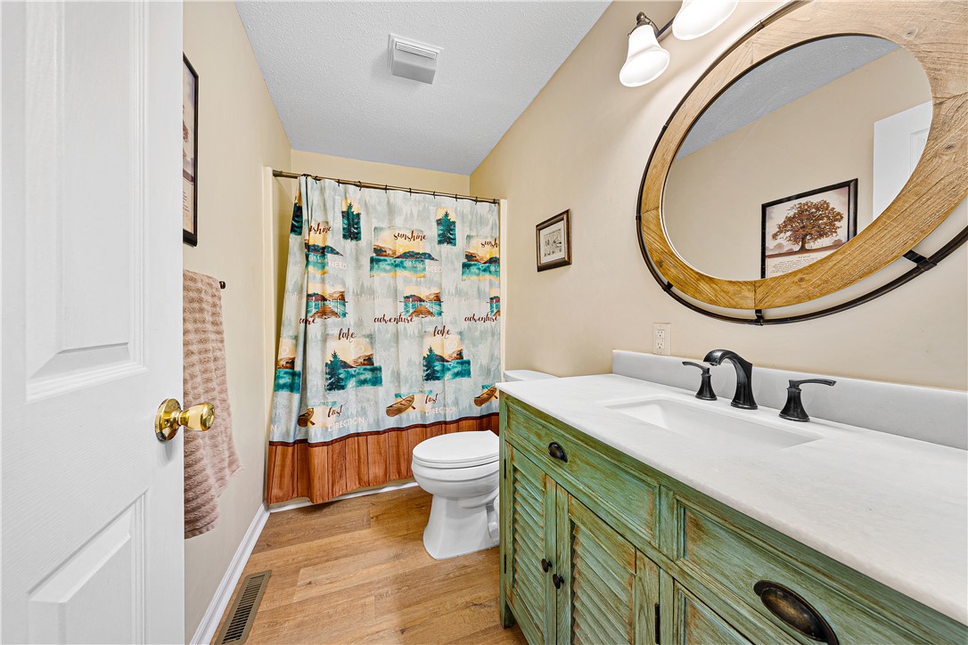 139 Tulip Lane Westminster, SC 29693 - Photo 11 of 37 A rustic-inspired vanity with a unique green finish anchors this well-appointed bathroom.