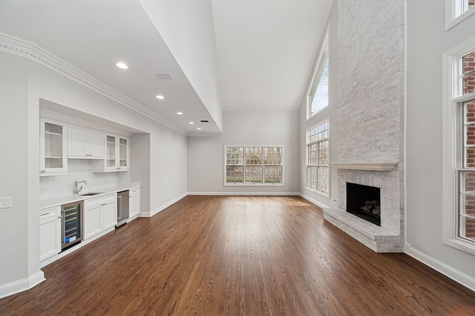 600 Broadsmoore Drive Lake Forest, IL 60045 - Photo 9 of 26 an empty room with wooden floor fireplace and windows