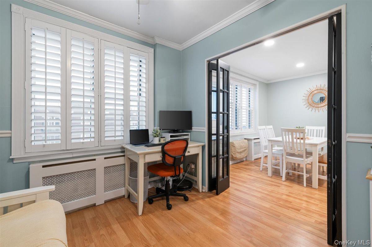 700 Shore Road, Unit 7Y Long Beach, NY 11561 - Photo 11 of 31 Home office featuring radiator heating unit, light wood finished floors, and crown molding