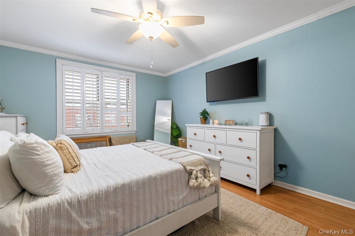 700 Shore Road, Unit 7Y Long Beach, NY 11561 - Photo 19 of 31 Bedroom featuring ornamental molding, light wood-type flooring, and ceiling fan