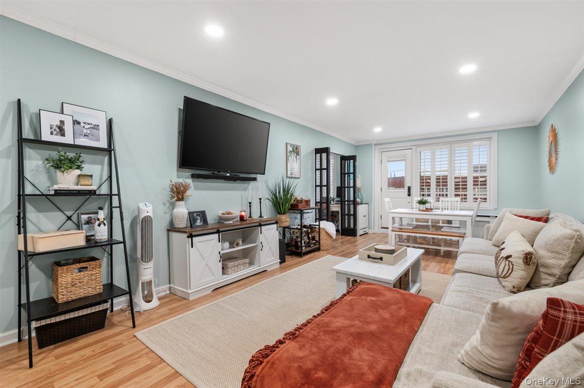700 Shore Road, Unit 7Y Long Beach, NY 11561 - Photo 2 of 31 Living room with light wood finished floors, recessed lighting, and crown molding